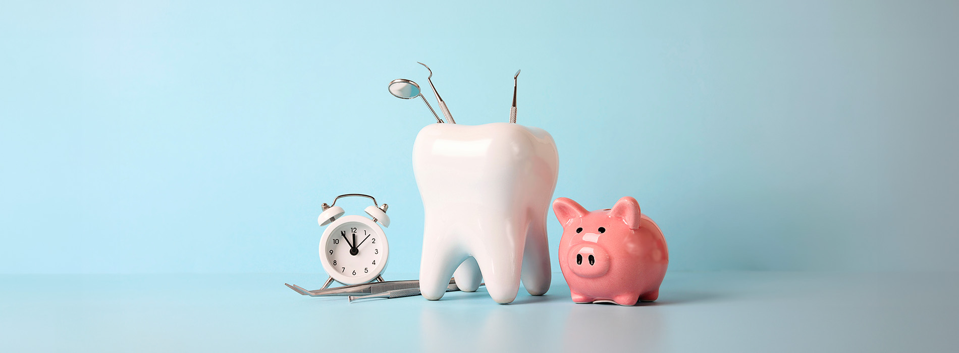 An image featuring two toothbrush holders with toothbrushes, a small piggy bank, and a clock on a blue background.